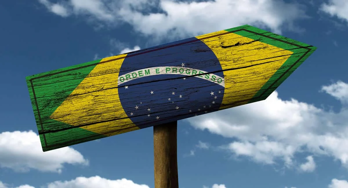 Seta de direção na estrada pintada com bandeira do Brasil